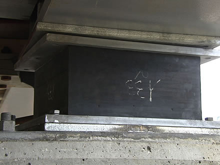 A rectangular lead rubber bearing is connected the bridge deck and the bridge pier.